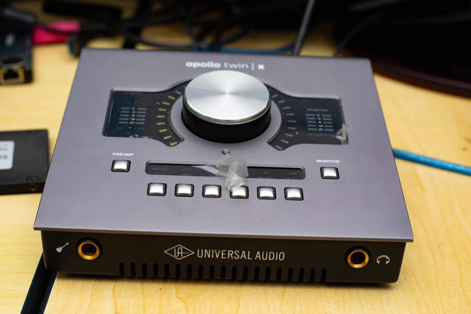 Universal Audio interface on the wooden SN7 studio desk.