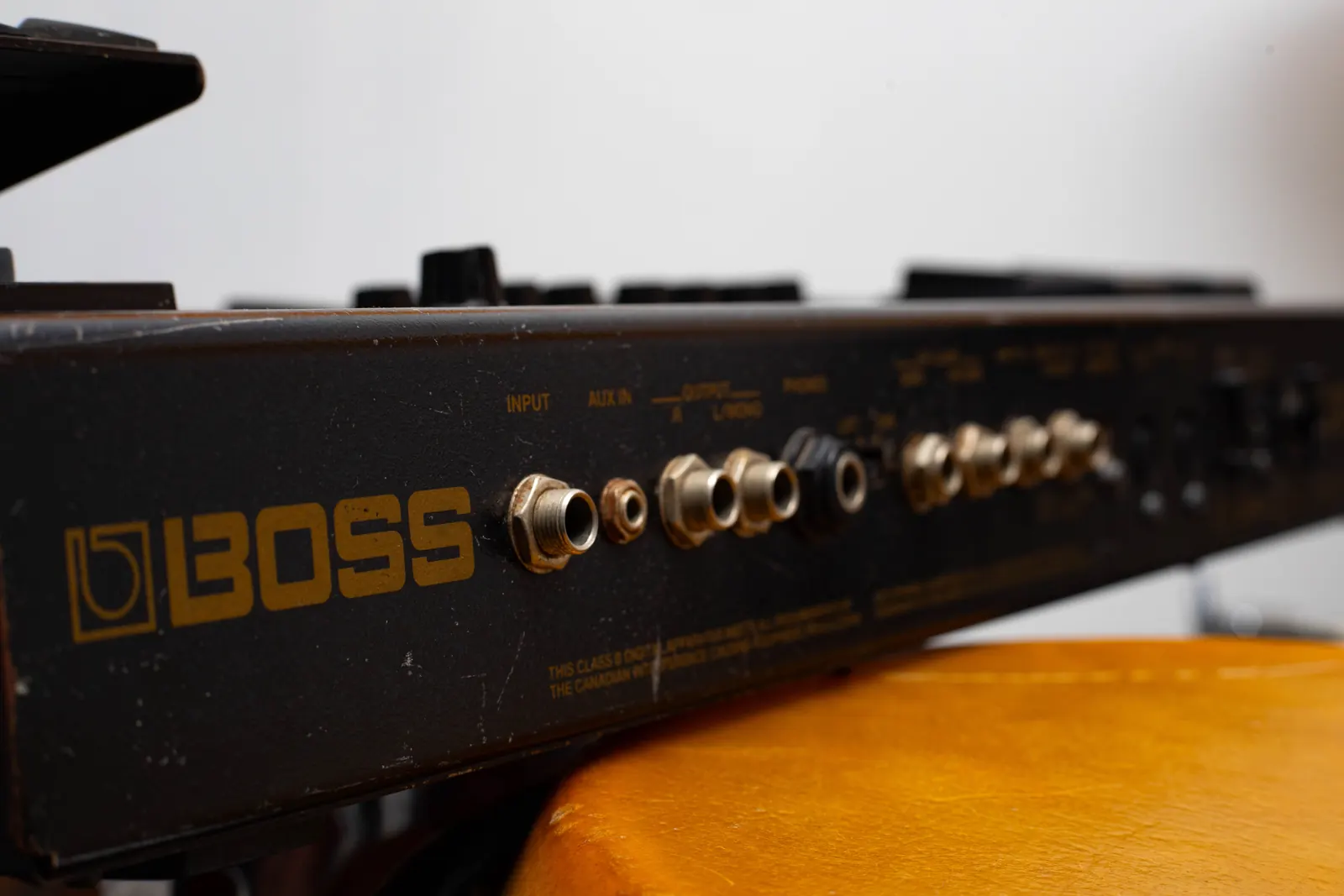 Bass pedals on a stand beside the live-room instruments.
