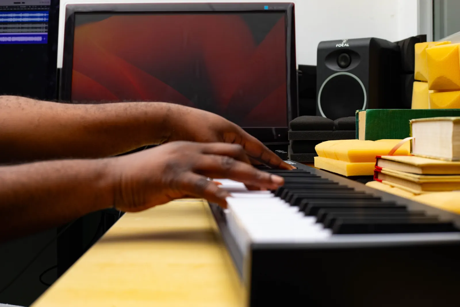 Hands playing a MIDI keyboard during a gospel production session at SN7.